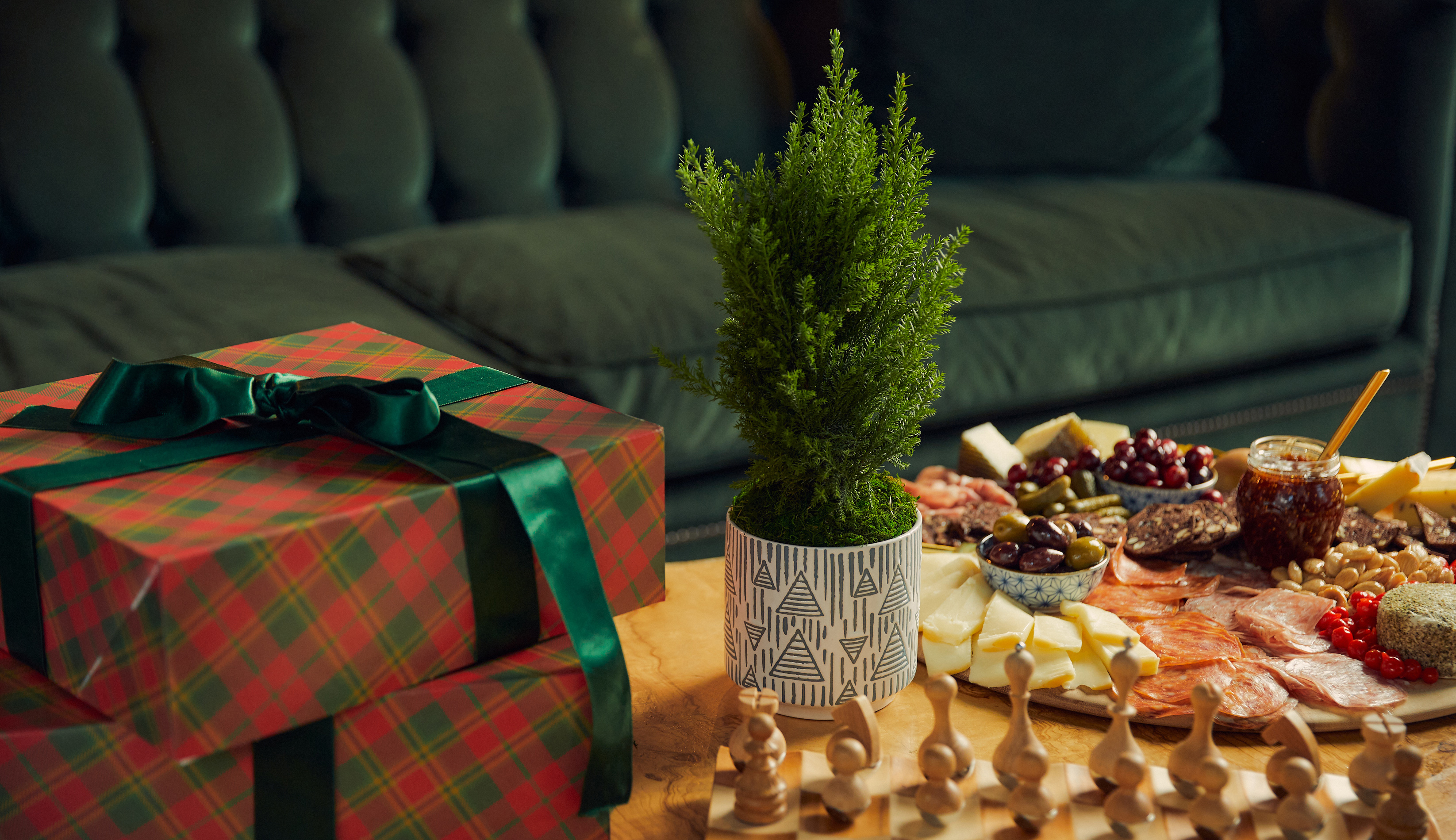Holiday gifts on a table next to holiday Christmas tree perfect for a holiday centerpiece